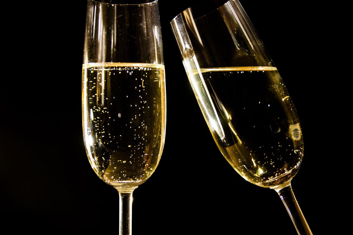 Two flutes of pale gold cava, the Catalan sparkling wine, catching the light